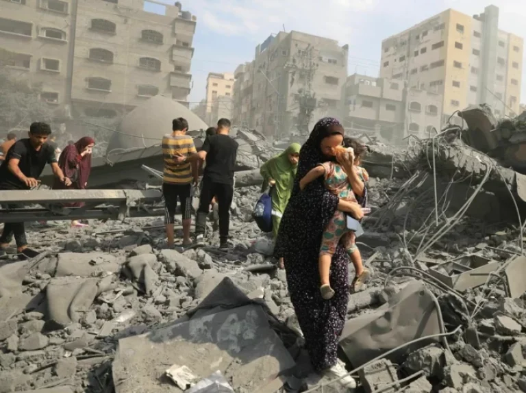 Palestinians evacuate the area following an Israeli airstrike on the Sousi mosque in Gaza City on October 9, 2023. Images of suffering, violence and death in Gaza and Israel have flooded the news since Oct. 7. MAHMUD HAMS/AFP via Getty Images"